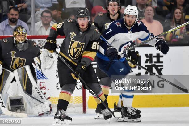 Nate Schmidt of the Vegas Golden Knights and Ben Chiarot of the Winnipeg Jets battle for position in Game Four of the Western Conference Final during...