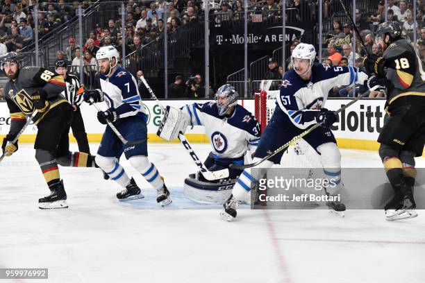 Ben Chiarot, Tyler Myers and Connor Hellebuyck of the Winnipeg Jets defend their goal against Alex Tuch and James Neal of the Vegas Golden Knights in...