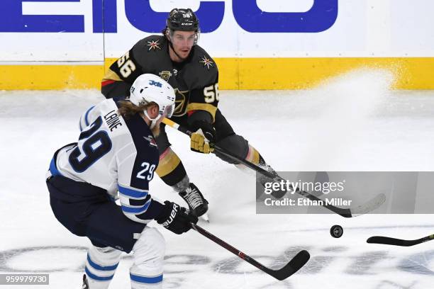 Erik Haula of the Vegas Golden Knights is defended by Patrik Laine of the Winnipeg Jets during the second period in Game Four of the Western...
