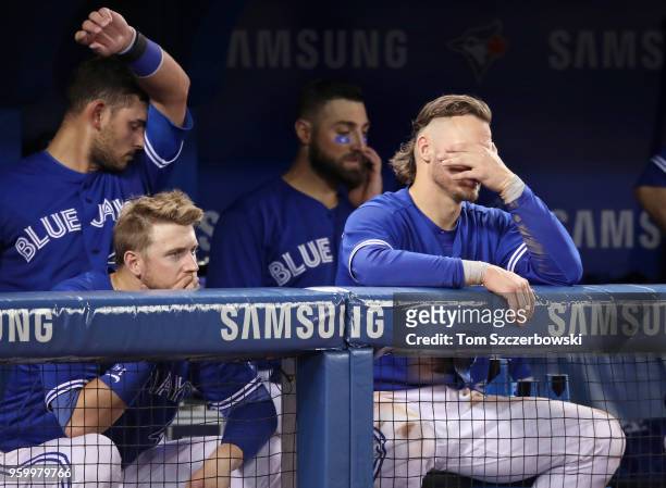 Justin Smoak of the Toronto Blue Jays and Josh Donaldson and Luke Maile and Kevin Pillar look on with two outs in the bottom of the ninth inning...
