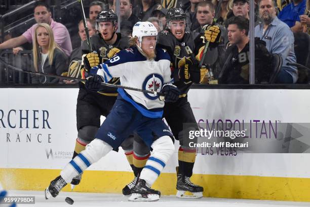 Patrik Laine of the Winnipeg Jets collides with Reilly Smith and Nate Schmidt of the Vegas Golden Knights in Game Four of the Western Conference...