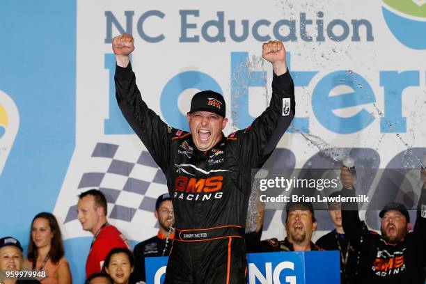 Johnny Sauter, driver of the ISM Connect Chevrolet, celebrates in Victory Lane after winning the NASCAR Camping World Truck Series North Carolina...