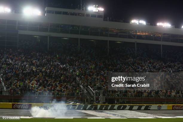Johnny Sauter, driver of the ISM Connect Chevrolet, celebrates with the a burnout after winning the NASCAR Camping World Truck Series North Carolina...