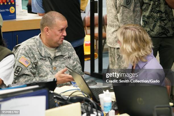 Photograph of Task Force Hawaii Public Affairs Officer Major Jeff Hickman and Hawaii County Public Information Officer Janet Snyder discussing media...