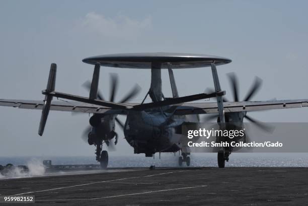 Photograph of an E-2D Hawkeye early warning aircraft taking off from the deck of the aircraft carrier USS Harry S. Truman, May 9, 2018.