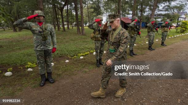 Photograph of Brigadier General Thomas Weidley saluting members of the Filipino armed forces during Exercise Balikatan training, Santa Ana, Cagayan,...