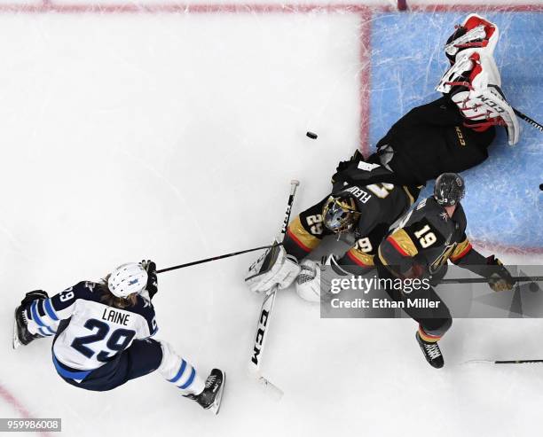 Marc-Andre Fleury of the Vegas Golden Knights blocks a shot by Patrik Laine of the Winnipeg Jets as Reilly Smith of the Golden Knights defends in the...