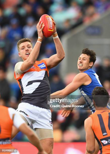 Aidan Corr of the Giants marks infront of Ben Jacobs of the Kangaroos during the round nine AFL match between the North Melbourne Kangaroos and the...
