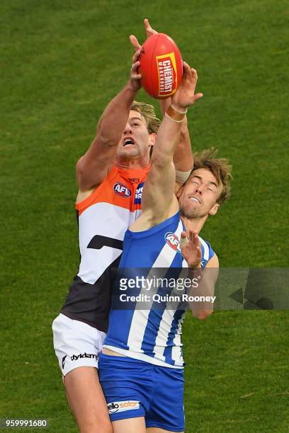 Lachlan Keeffe of the Giants marks over the top of Trent Dumont of the Kangaroos during the round nine AFL match between the North Melbourne...
