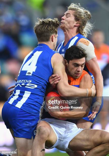 Tim Taranto of the Giants is tackled by Trent Dumont and Jed Anderson of the Kangaroos during the round nine AFL match between the North Melbourne...