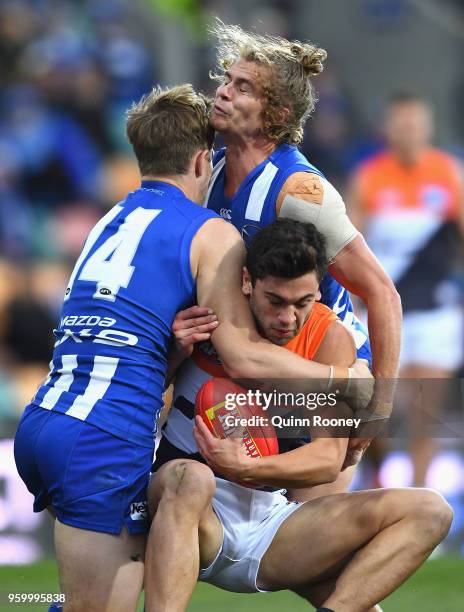 Tim Taranto of the Giants is tackled by Trent Dumont and Jed Anderson of the Kangaroos during the round nine AFL match between the North Melbourne...