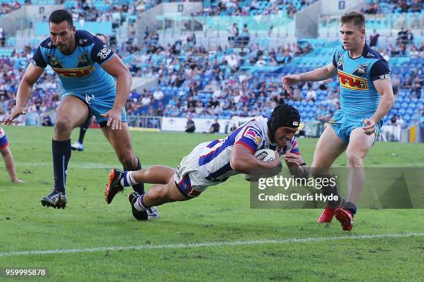 Sione Mata'Utia of the Knights dives to score a try during the round 11 NRL match between the Gold Coast Titans and the Newcastle Knights at Cbus...