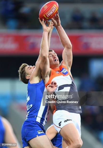 Adam Tomlinson of the Giants marks infront of Mason Wood of the Kangaroos during the round nine AFL match between the North Melbourne Kangaroos and...