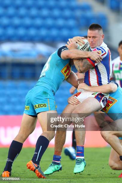 Shaun Kenny-Dowall of the Knights is tackled during the round 11 NRL match between the Gold Coast Titans and the Newcastle Knights at Cbus Super...
