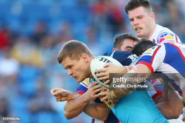 Dale Copley of the Titans is tackled during the round 11 NRL match between the Gold Coast Titans and the Newcastle Knights at Cbus Super Stadium on...