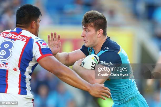 Jai Arrow of the Titans is tackled during the round 11 NRL match between the Gold Coast Titans and the Newcastle Knights at Cbus Super Stadium on May...