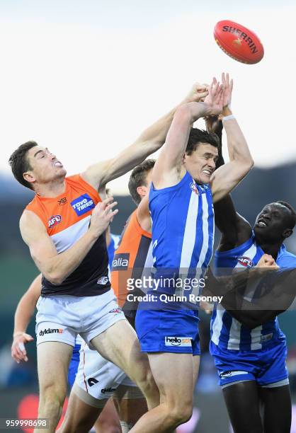 Jeremy Cameron of the Giants and Scott Thompson of the Kangaroos compete for a mark during the round nine AFL match between the North Melbourne...