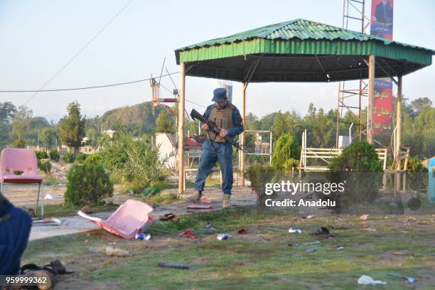 Member of a security official inspects the area after three blasts, which killed 8, at the Afghan cricket stadium in Jalalabad city center of...