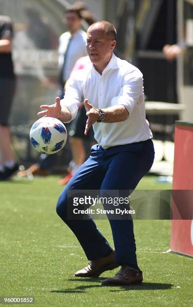 Head coach Giovanni Savarese of the Portland Timbers tosses the ball back on to the pitch during the second half of the match against the Seattle...