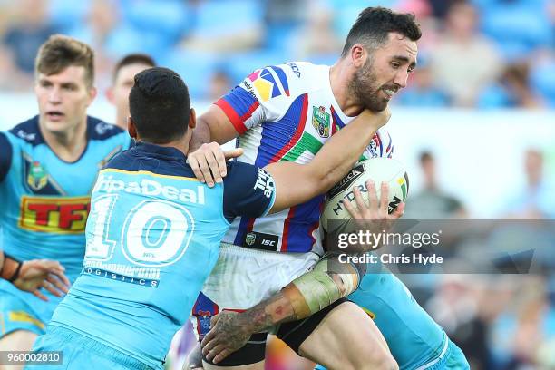 Connor Watson of the knights is tackled during the round 11 NRL match between the Gold Coast Titans and the Newcastle Knights at Cbus Super Stadium...