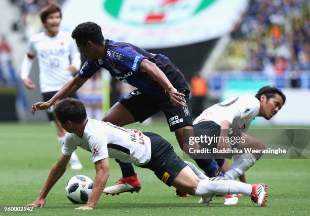 Fabio of Gamba Osaka and Kazuki Nagasawa of Urawa Red Diamonds compete for the ball during the J.League J1 match between Gamba Osaka and Urawa Red...
