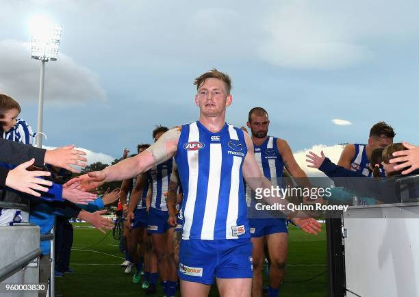 Jack Ziebell of the Kangaroos leads his team off the field after winning the round nine AFL match between the North Melbourne Kangaroos and the...