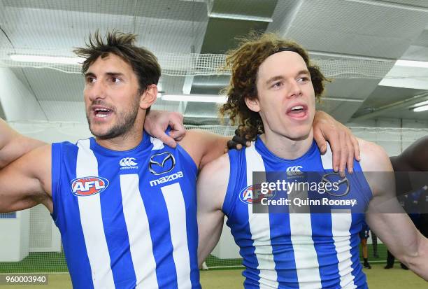 Jarrad Waite and Ben Brown of the Kangaroos sing the song in the rooms after winning the round nine AFL match between the North Melbourne Kangaroos...
