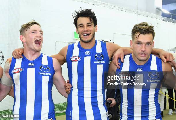 Jack Ziebell, Robbie Tarrant and Shaun Higgins of the Kangaroos sing the song in the rooms after winning the round nine AFL match between the North...