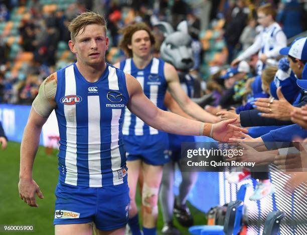 Jack Ziebell of the Kangaroos high fives fans after winning the round nine AFL match between the North Melbourne Kangaroos and the Greater Western...