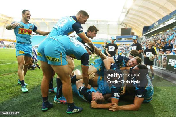 Alexander Brimson of the Titans celebrates a try with team mates during the round 11 NRL match between the Gold Coast Titans and the Newcastle...
