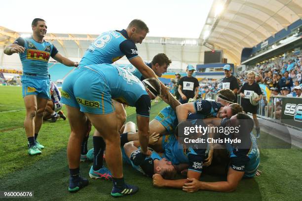 Alexander Brimson of the Titans celebrates a try with team mates during the round 11 NRL match between the Gold Coast Titans and the Newcastle...