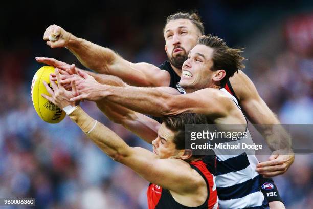 Patrick Ambrose of the Bombers and Cale Hooker of the Bombers compete for the ball against Tom Hawkins of the Cats during the round nine AFL match...