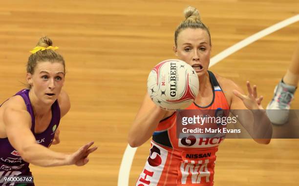 Gabi Simpson of the Firebirds and Kim Green of the Giants compete for the ball during the round four Super Netball match between the Giants and the...