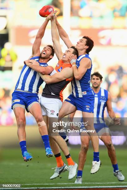 Jeremy Cameron of the Giants competes for a mark against Jamie Macmillan and Scott Thompson of the Kangaroos during the round nine AFL match between...