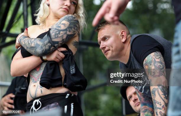 Jurors evaluate a tattoo during the International Tattoo Convention &quot;Tattoo Collection 2018&quot; in Kyiv, Ukraine, May 18, 2018. 14-th...