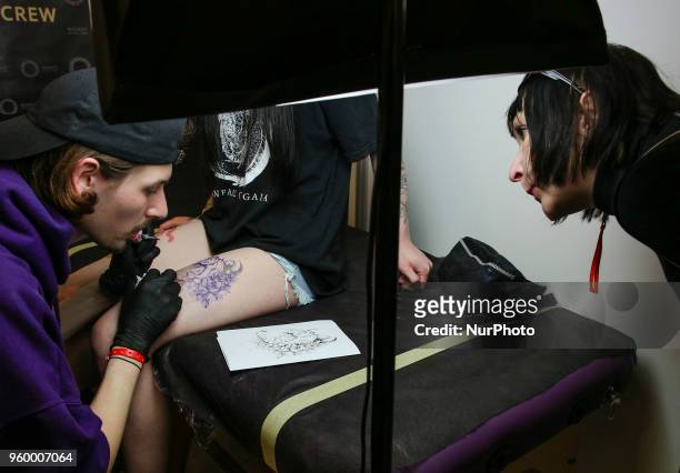 Tattoo artist makes a tattoo for festival attendee during the International Tattoo Convention &quot;Tattoo Collection 2018&quot; in Kyiv, Ukraine,...
