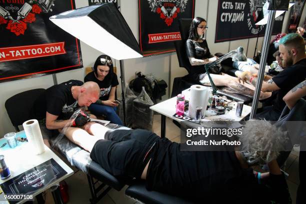 Tattoo artist makes a tattoo for festival attendee during the International Tattoo Convention &quot;Tattoo Collection 2018&quot; in Kyiv, Ukraine,...