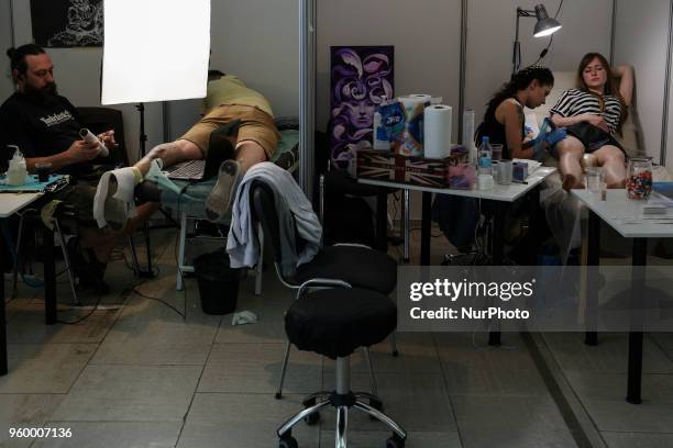 Tattoo artist makes a tattoo for festival attendee during the International Tattoo Convention &quot;Tattoo Collection 2018&quot; in Kyiv, Ukraine,...