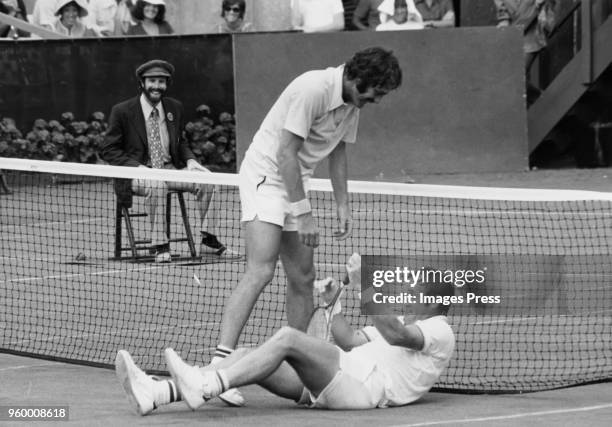 John Newcombe helps Tony Roche up on September 1, 1974 in Forest Hills, Queens.