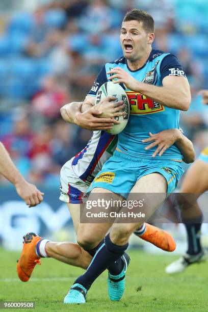 Anthony Don of the Titans is tackled during the round 11 NRL match between the Gold Coast Titans and the Newcastle Knights at Cbus Super Stadium on...