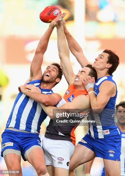 Jeremy Cameron of the Giants competes for a mark against Jamie Macmillan and Scott Thompson of the Kangaroos during the round nine AFL match between...