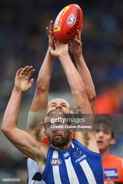 Nick Haynes of the Giants and Ben Cunnington of the Kangaroos compete for a mark during the round nine AFL match between the North Melbourne...