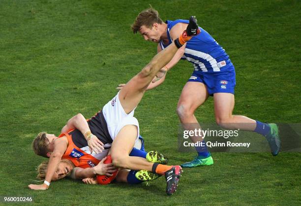 Nick Haynes of the Giants is tackled by Jack Ziebell of the Kangaroos during the round nine AFL match between the North Melbourne Kangaroos and the...