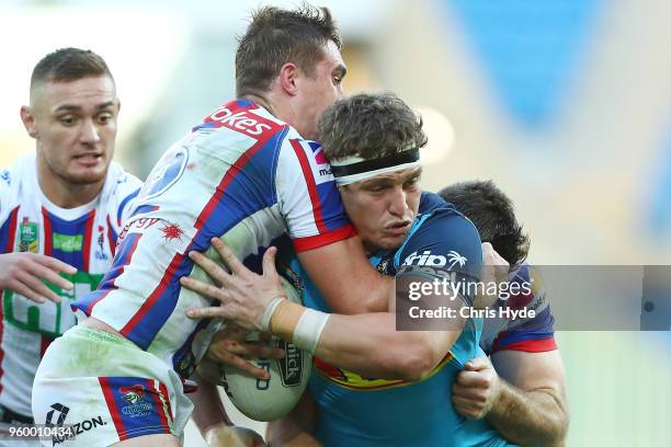 Jarrod Wallace of the Titans is tackled during the round 11 NRL match between the Gold Coast Titans and the Newcastle Knights at Cbus Super Stadium...