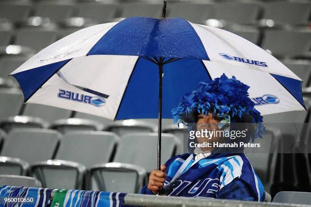 Blues fan looks on in the rain during the round 14 Super Rugby match between the Blues and the Crusaders at Eden Park on May 19, 2018 in Auckland,...