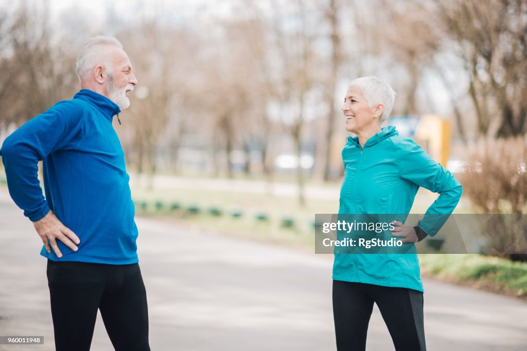 Athletic senior couple stretching outdoors
