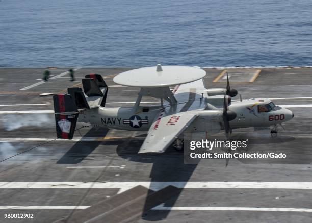 Photograph of an E-2C Hawkeye early warning aircraft landing aboard the aircraft carrier USS George HW Bush during joint US-France navy training...
