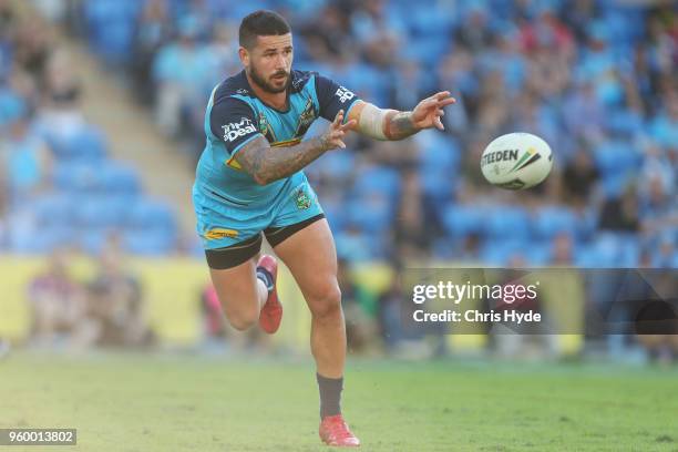 Nathan Peats of the Titans passes during the round 11 NRL match between the Gold Coast Titans and the Newcastle Knights at Cbus Super Stadium on May...