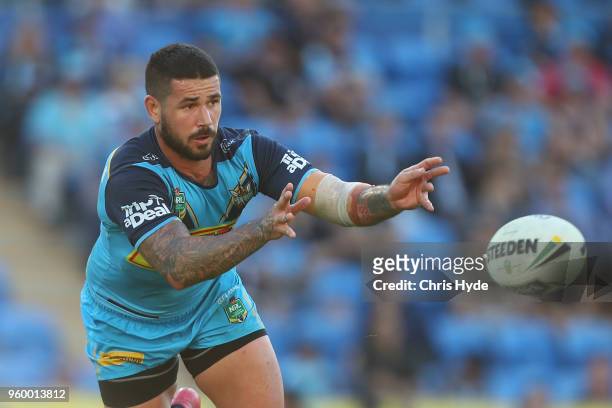Nathan Peats of the Titans passes during the round 11 NRL match between the Gold Coast Titans and the Newcastle Knights at Cbus Super Stadium on May...