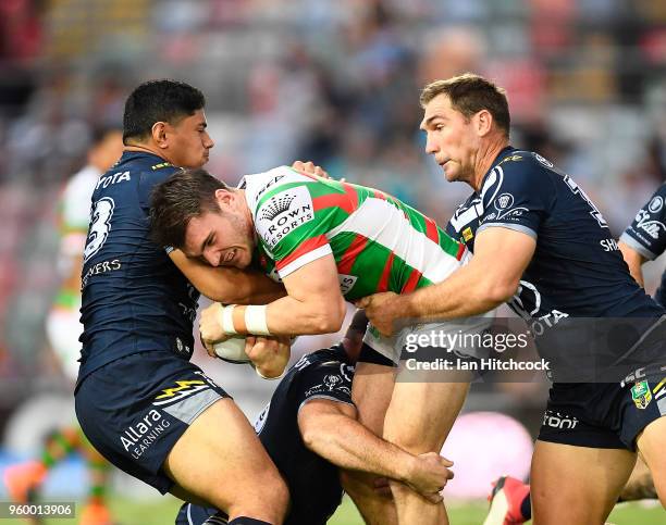 Angus Crichton of the Rabbitohs is tackled by Jason Taumalolo and Scott Bolton of the Cowboys during the round 11 NRL match between the North...